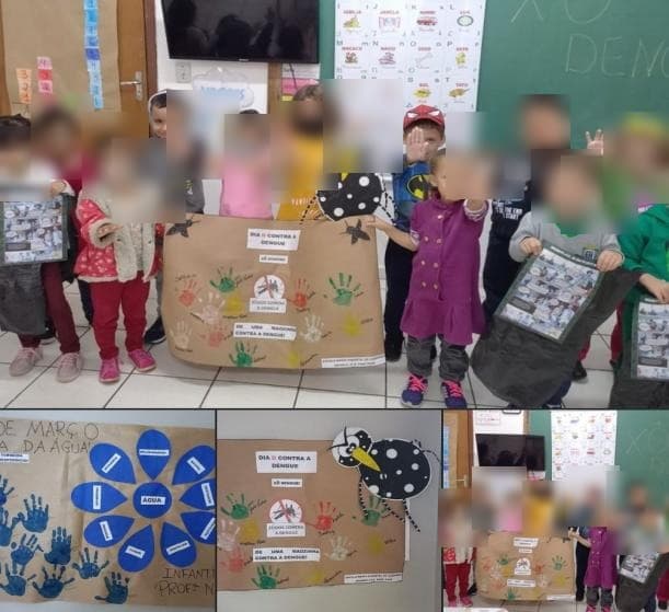 Crianças e cartazes de uma campanha escolar de combate à dengue.